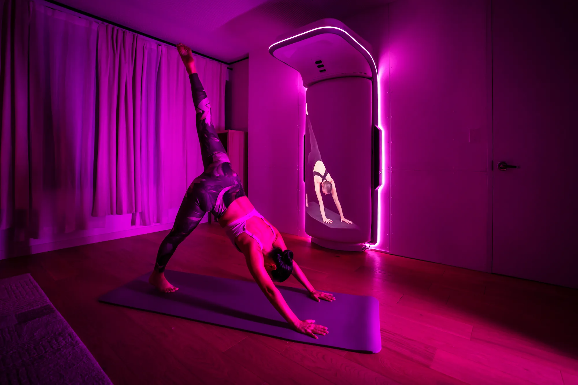 A woman practicing yoga and pilates with Growl's boxing bag